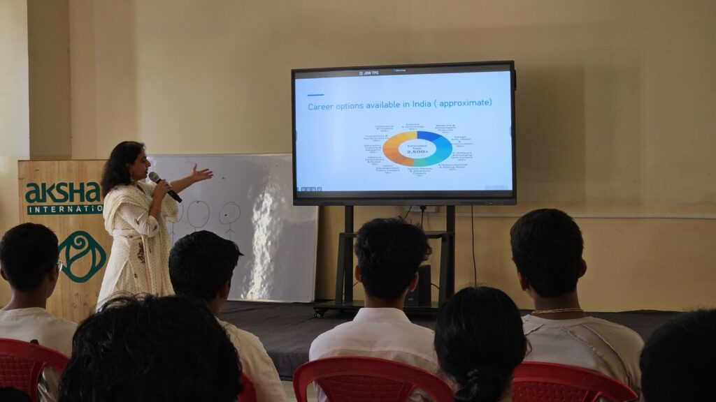 A woman presenting to an audience, engaging them with her speech and visuals.